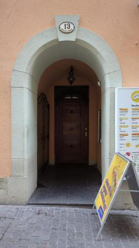 an entrance to a building with a clock above a door at A&Y Oldtown Penthouse Loft Luzern in Luzern