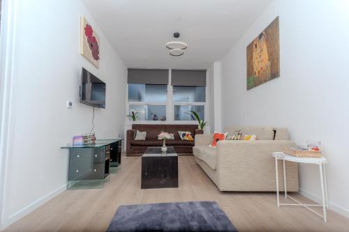 a living room with a couch and a table at One Bedroom apartment Serviced apartment Smethwick flat 320 in Birmingham