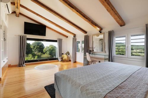 a bedroom with a bed and a large window at Villa n.RICCIO in Sokrakion