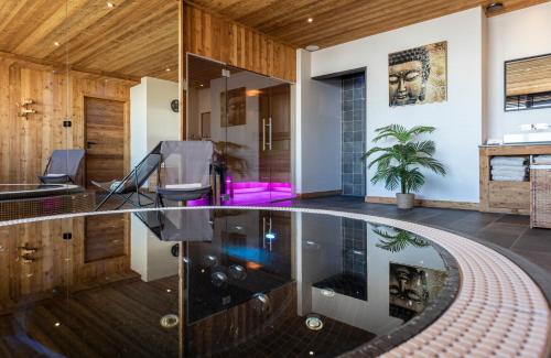 an indoor pool in the middle of a house at Chalet Cullinan by Les Etincelles in Val Thorens