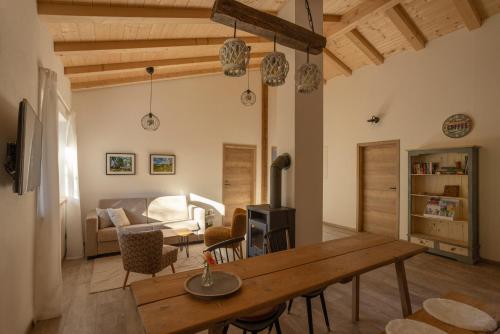 a living room with a wooden table and a couch at Ferienwohnung Zum Lenei in Staudach-Egerndach