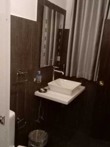 a bathroom with a sink and a mirror at The Bliss Hostel Kandy in Kandy