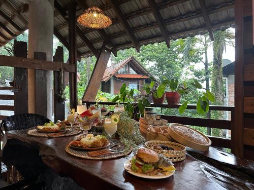 a table with plates of food on it at Moon hill camp in Kampong Egang