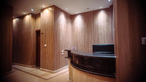 a hallway with wooden walls and a podium in a room at Rotana Palace Suites in Cairo