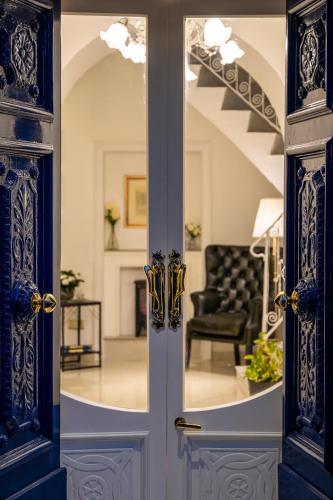 an open door into a living room with a couch at The Siggiewi Suites in Siġġiewi