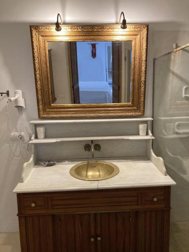 a bathroom with a sink with a gold mirror at La Bohemia del Rio Boutique Hotel - Adults Only in Santa Eularia des Riu