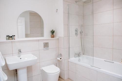 a bathroom with a sink and a toilet and a shower at Flackley Ash Country House Hotel in Rye