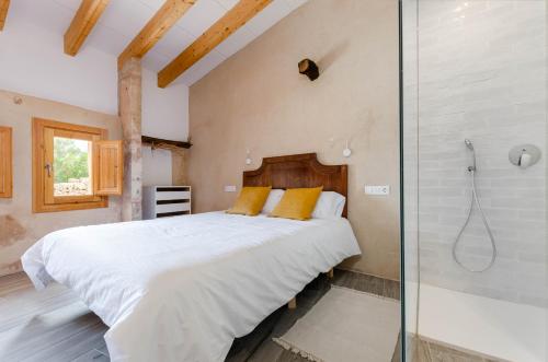 a bedroom with a large bed and a shower at Cal Tio 2 Agroturismo YourHouse in Costitx