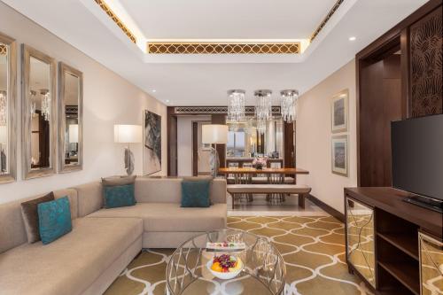 a living room with a couch and a tv at Hilton Dubai Al Habtoor City in Dubai