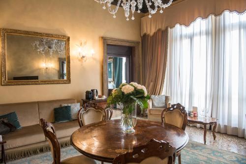 a living room with a vase of flowers on a table at Hotel Nani Mocenigo Palace in Venice