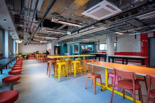a cafeteria with colorful tables and chairs in a room at Clink i Lár in Dublin