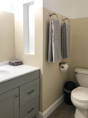 a bathroom with a white sink and a toilet at TriLuxe Inn & Studios in Fort Myers