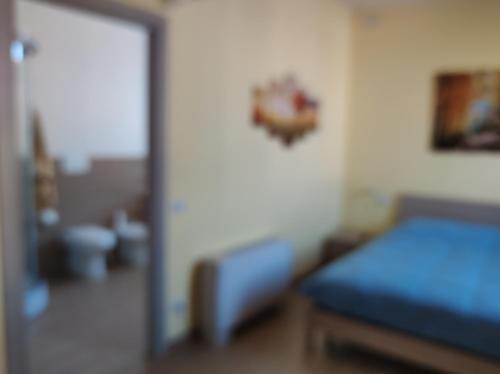 a bedroom with a blue bed and a doorway at Villa ARA blu in Canegrate