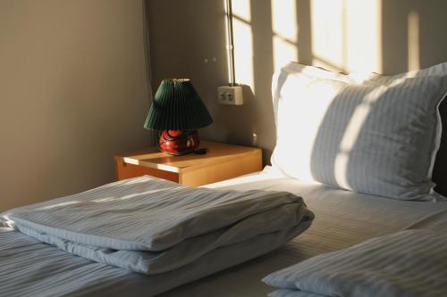 a bedroom with a bed with a lamp on a night stand at JR's House in Yerevan