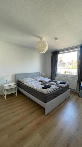 a bedroom with a bed and a large window at Air Apartments 5 in Bremen