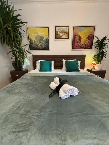 a bed with a stuffed animal laying on it at Stylish King Downtown in Podgorica