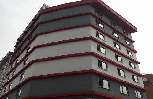 a tall black and white building with white windows at ONKA OTEL in Zonguldak