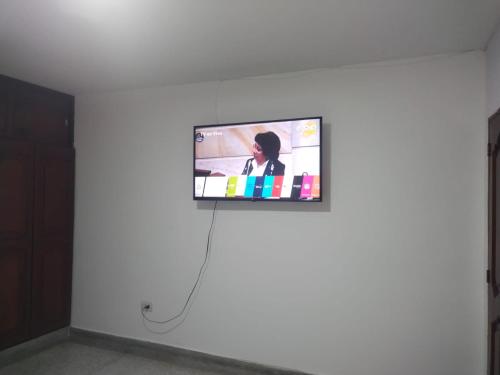 a flat screen tv hanging on a white wall at Hotel Los Arcángeles in Cúcuta