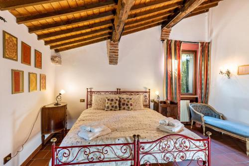 a bedroom with a large bed in a room with wooden ceilings at Casa Rossa Vendri in Verona