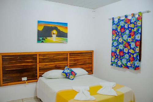 a bedroom with two beds and a window at Pousada Jeri Flats in Jericoacoara
