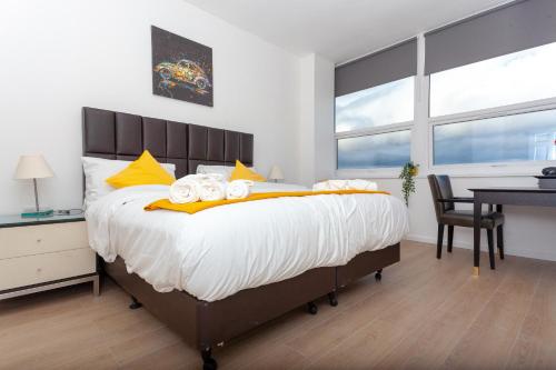 a bedroom with a large bed with towels on it at One bedroom serviced apartment Smethwick flat 310 in Birmingham