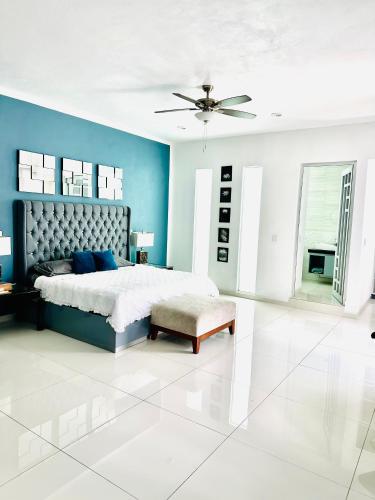 a bedroom with a bed with blue walls and a ceiling at Casa del Diseño in Uruapan del Progreso