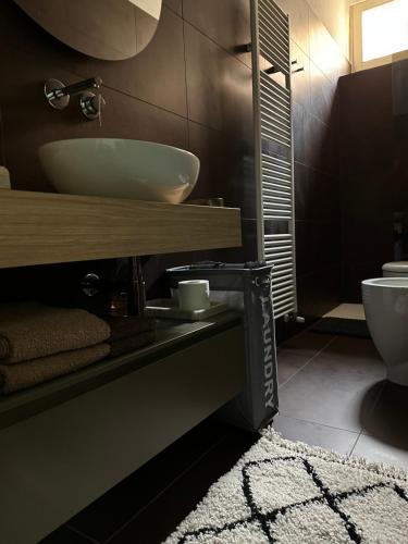 a bathroom with a sink and a toilet at ARCHIVIO MANZONI 37 in Cremona
