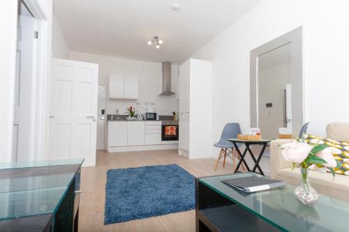a living room with a couch and a table at One Bedroom Serviced apartments Flat 311 in Birmingham