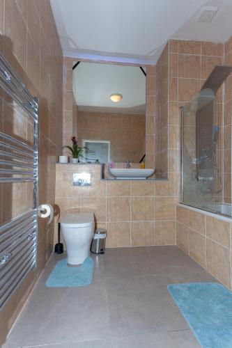 a tiled bathroom with a toilet and a sink at One Bedroom Serviced apartments Flat 311 in Birmingham