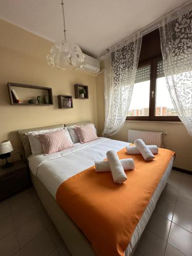 a bedroom with a large bed with two pillows on it at THE HOUSE OF SUNSETS in Rome