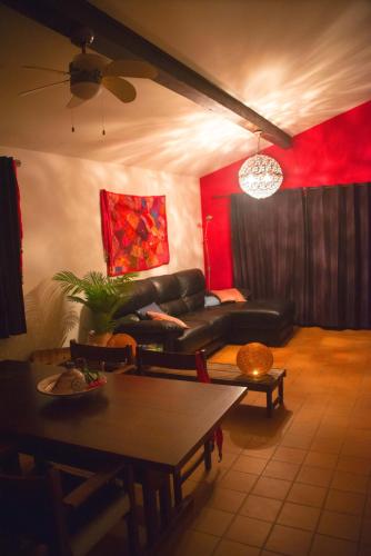 a living room with a couch and a table at Le Jardin des Copains in Canet