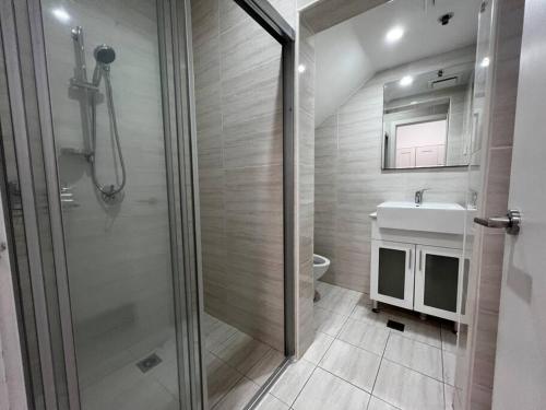 a bathroom with a shower and a toilet and a sink at CBD Pink!Studio 1 Bedroom FreeParking in Sydney