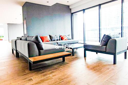 a living room with a couch and two chairs at Next2Mall at Sunway Velocity Two by HCK in Kuala Lumpur