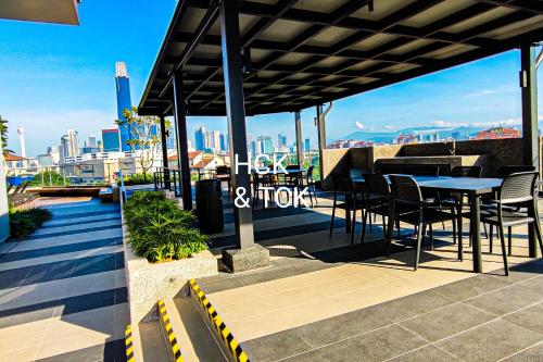 a patio with a table and chairs and a view of the city at Next2Mall at Sunway Velocity Two by HCK in Kuala Lumpur