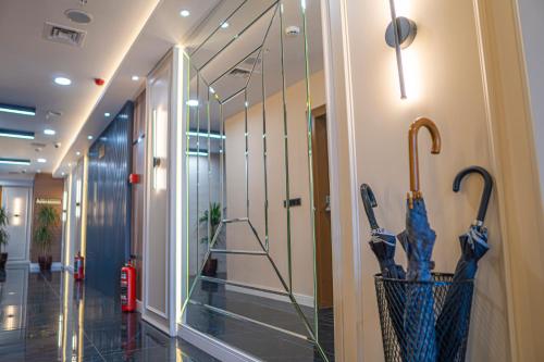 a hallway with umbrellas on the wall in a building at Istanbul Midpoint Hotel in Istanbul