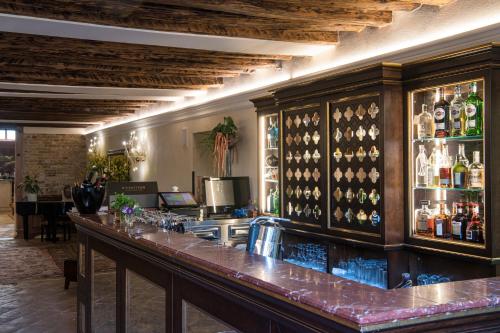 a bar with a lot of bottles of alcohol at Hotel Nani Mocenigo Palace in Venice
