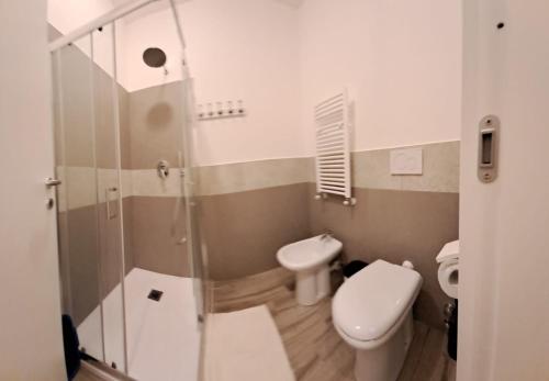 a bathroom with a toilet and a glass shower at Casa Betti in Rapallo