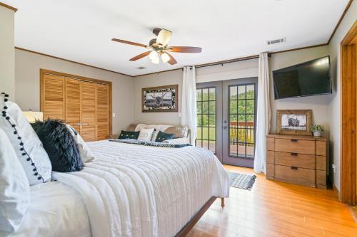 a bedroom with a bed and a ceiling fan at Lil Yellowstone in Morganton