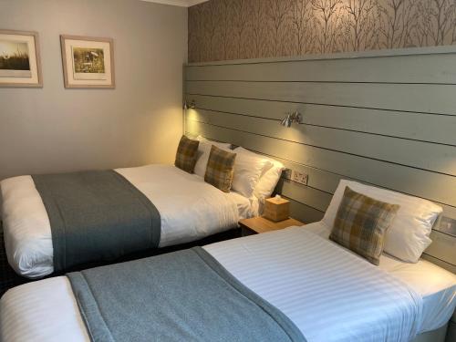 a hotel room with two beds in a room at Village Inn in Arrochar