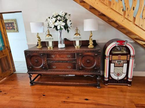 an old wooden cabinet with a vase of flowers on it at Valley View Eco Country Estate - Paradise in the Winelands in Villiersdorp