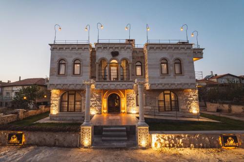 a large stone house with lights in front of it at Leda Stone House in Nevsehir