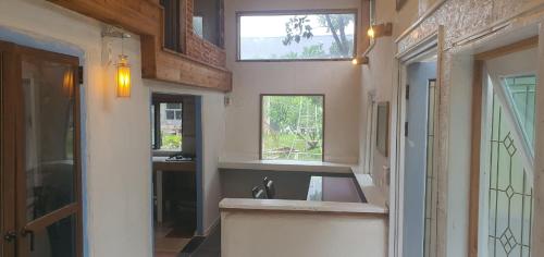 a kitchen with a sink and a window at Tasha's Garden in Jeju