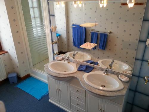 a bathroom with two sinks and a shower at Chavot Bellevue in Chavot-Courcourt