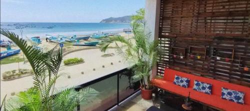 a view of a beach from a building with palm trees at 100m2 Front Beach private apartment in Puerto López