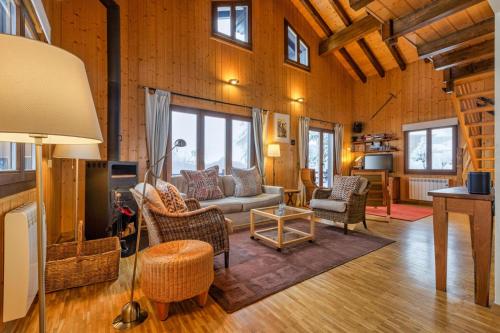 a living room with a couch and chairs at Chalet Les Jeunes - Swiss Ski Chalet with amazing views 8pax in Riddes