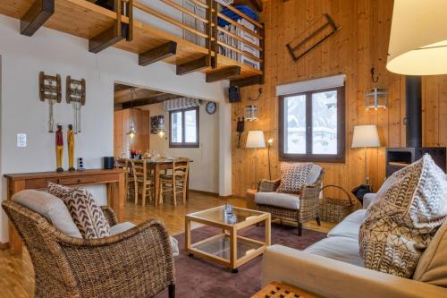 a living room with a couch and chairs and a table at Chalet Les Jeunes - Swiss Ski Chalet with amazing views 8pax in Riddes