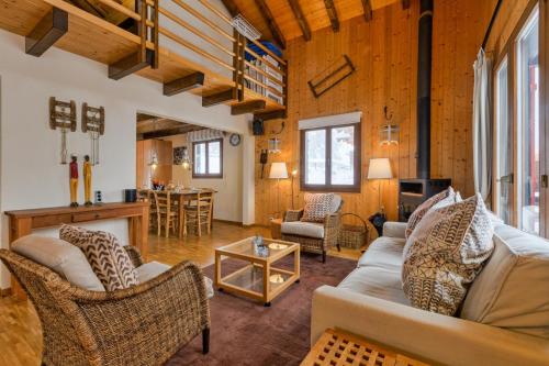 a living room with a couch and a table at Chalet Les Jeunes - Swiss Ski Chalet with amazing views 8pax in Riddes