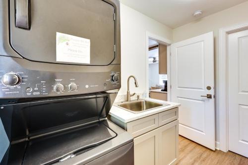 a kitchen with a sink and a stove at 4 Mi to Beach Wilmington Home with Gazebo Deck! in Wilmington