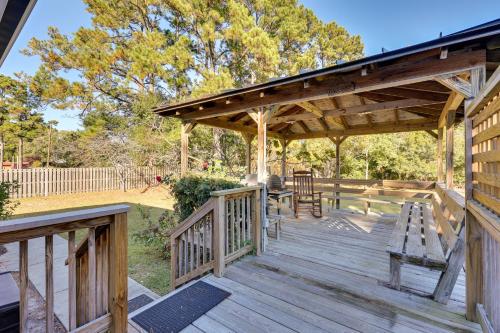 a wooden deck with a pavilion with a table and chairs at 4 Mi to Beach Wilmington Home with Gazebo Deck! in Wilmington