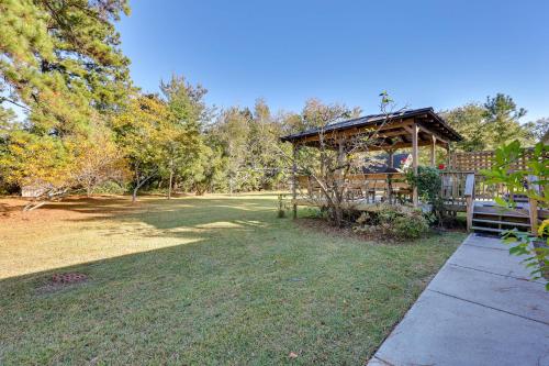 a gazebo with a bench in a yard at 4 Mi to Beach Wilmington Home with Gazebo Deck! in Wilmington